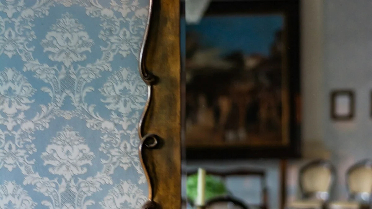 A figure standing in an open doorway at dawn — a The Obsidian Key guide to The Assumed State.