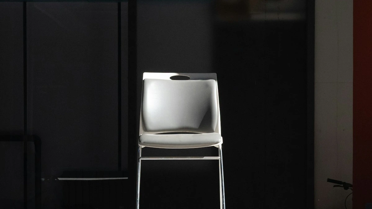 A single pale chair stands under a hard light against a dark glass wall. — a The Obsidian Key guide to Assumption Mistakes: Pretending, Optimism, Browsing.