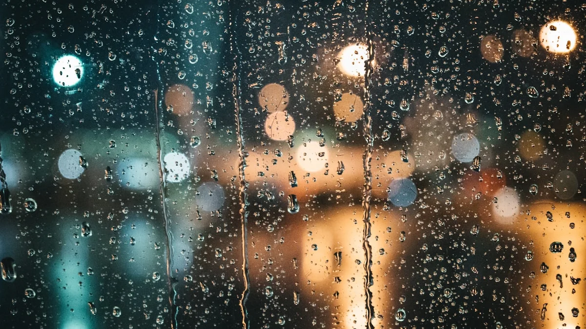 Raindrops streak a dark window at night with warm amber lights glowing blurred beyond the glass. — a The Obsidian Key guide to Borrowed Moods: Why Rooms Change How You Feel.