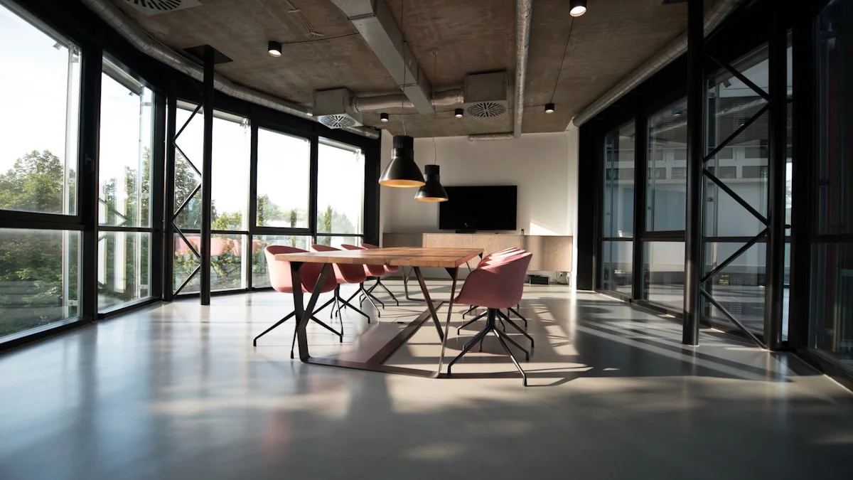 Warm pendant lamps glow over an empty meeting room table in late daylight. — a The Obsidian Key guide to Carrying the Flame Into Meetings: Protection at Work.