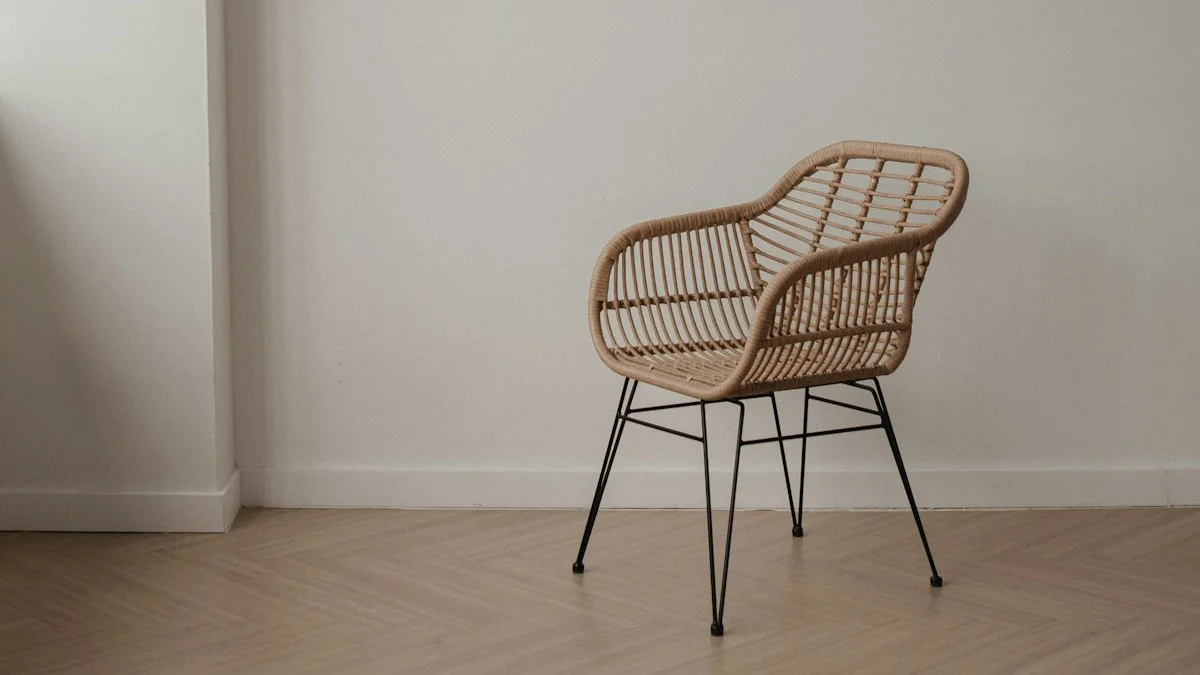 A single wicker chair with black metal legs stands against a pale wall on a wooden floor. — a The Obsidian Key guide to The Chair That Is Not the Bed.
