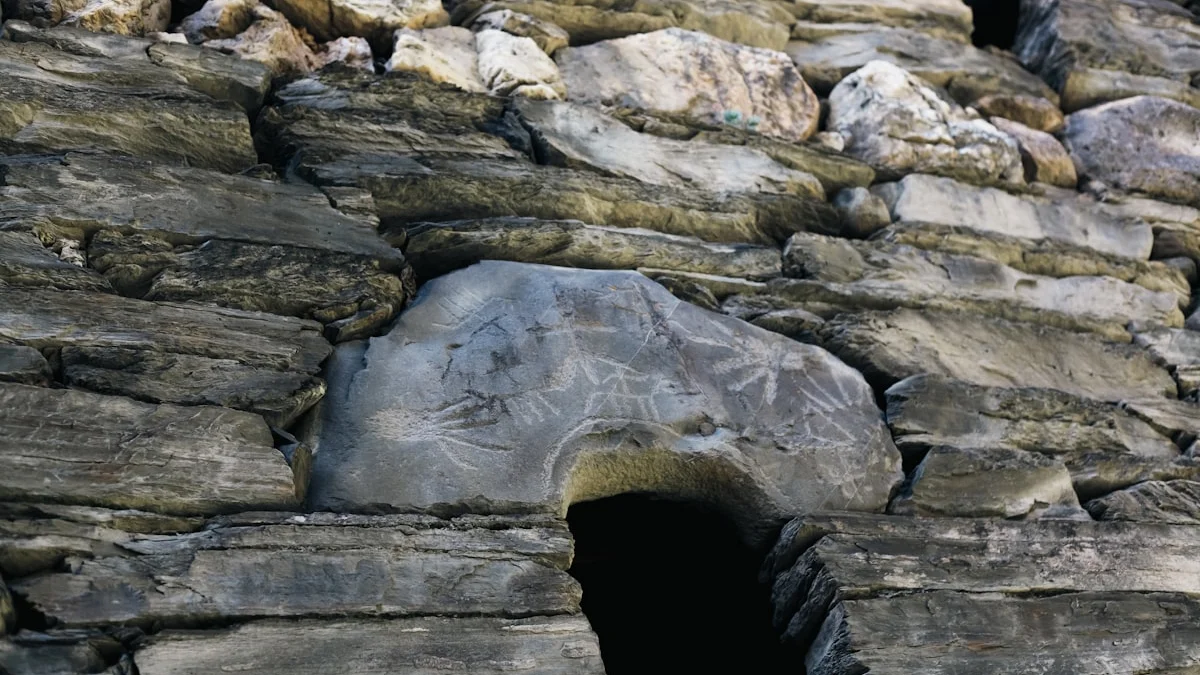 A dark slate stone wall of layered rocks with a small black opening at its base. — a The Obsidian Key guide to The Day 3 Wall: When Thoughts Grow Louder First.