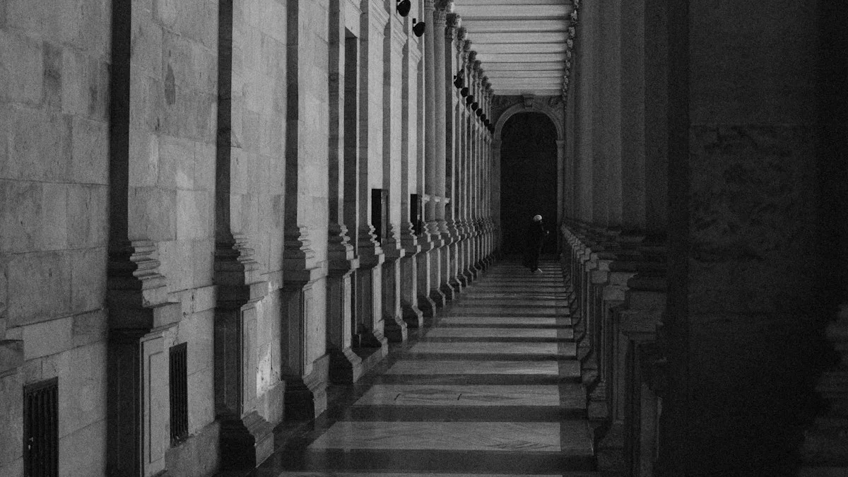 A long stone colonnade recedes toward a distant figure at its far end. — a The Obsidian Key guide to Get the Discernment Checklist Before Your Next Course.