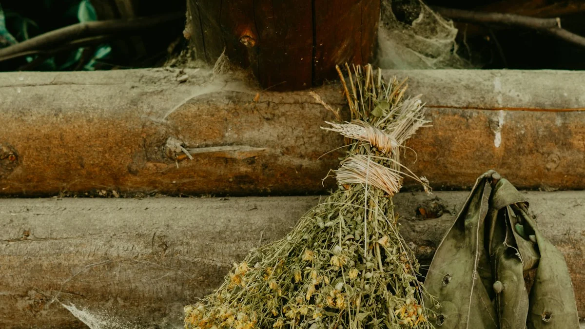 A bundle of dried herbs tied with twine hangs against weathered wooden logs beside an old coat. — a The Obsidian Key guide to Emotional Discharge: What Surfaces When Noise Thins.