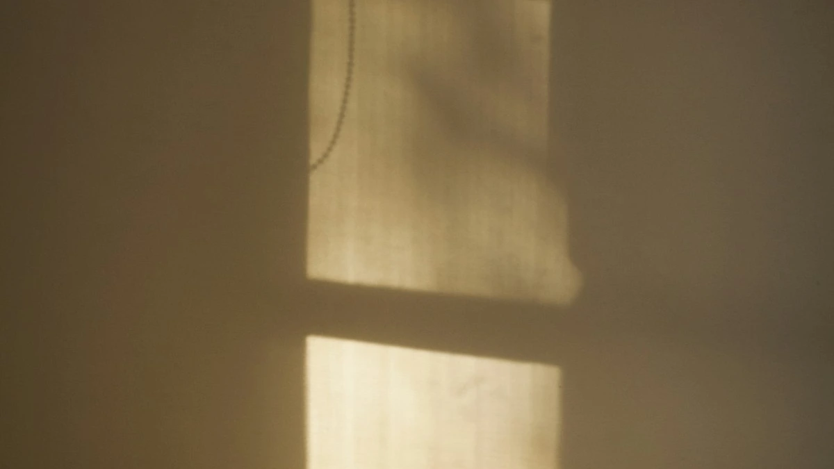 Soft morning sunlight falling in bright patches across a plain interior wall. — a The Obsidian Key guide to First Steps: Ninety Seconds of Stillness.