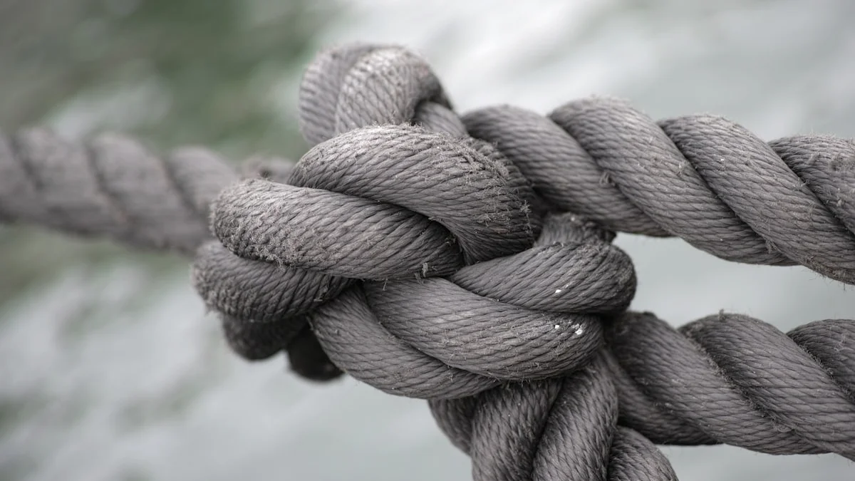 A thick rope tied in a heavy knot against grey water. — a The Obsidian Key guide to Five Mistakes That Undo a Sealing.