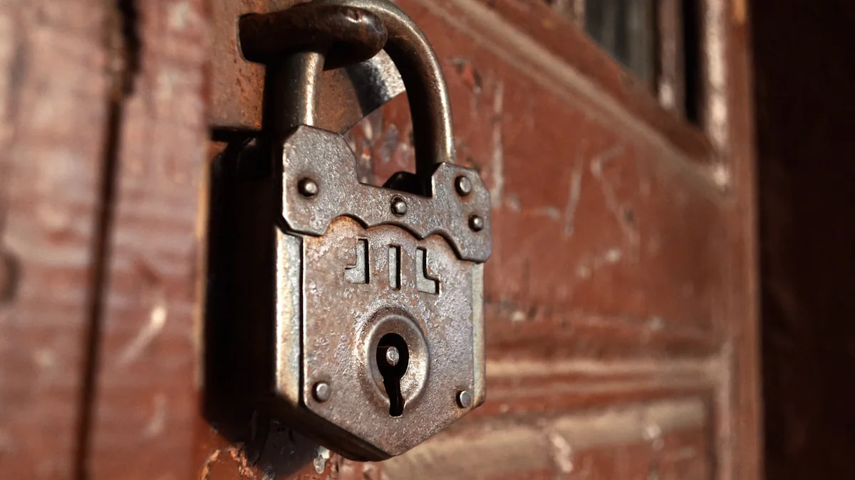 An old rusted padlock clasped through the handle of a weathered red wooden door. — a The Obsidian Key guide to Hoarding vs Saving: The Line the Doctrine Draws.