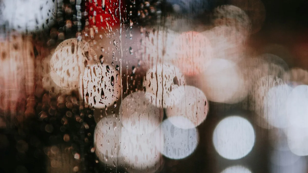 Raindrops streaking down a window glass with warm blurred lights beyond at dusk. — a The Obsidian Key guide to How Feelings Become Circumstances in the Field.