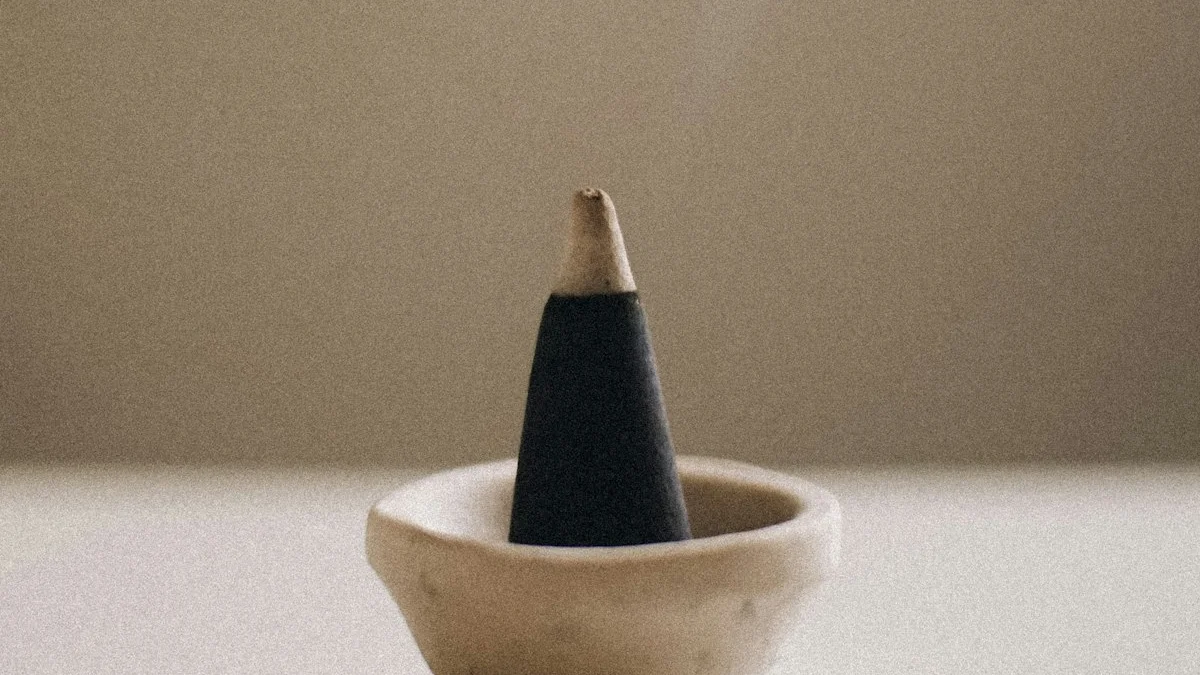 A cone of incense smolders in a small stone bowl, thin smoke rising. — a The Obsidian Key guide to How Often to Cleanse: Monthly Maintenance and After Conflict.