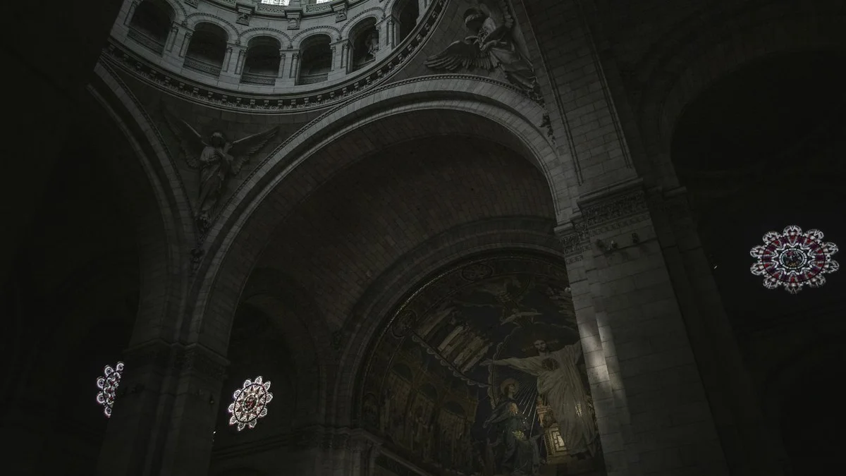 Tiered arches, statues, and vaulted ceilings rise inside a vast, dimly lit cathedral. — a The Obsidian Key guide to How the Obsidian Key Is Structured: Parts I to III.
