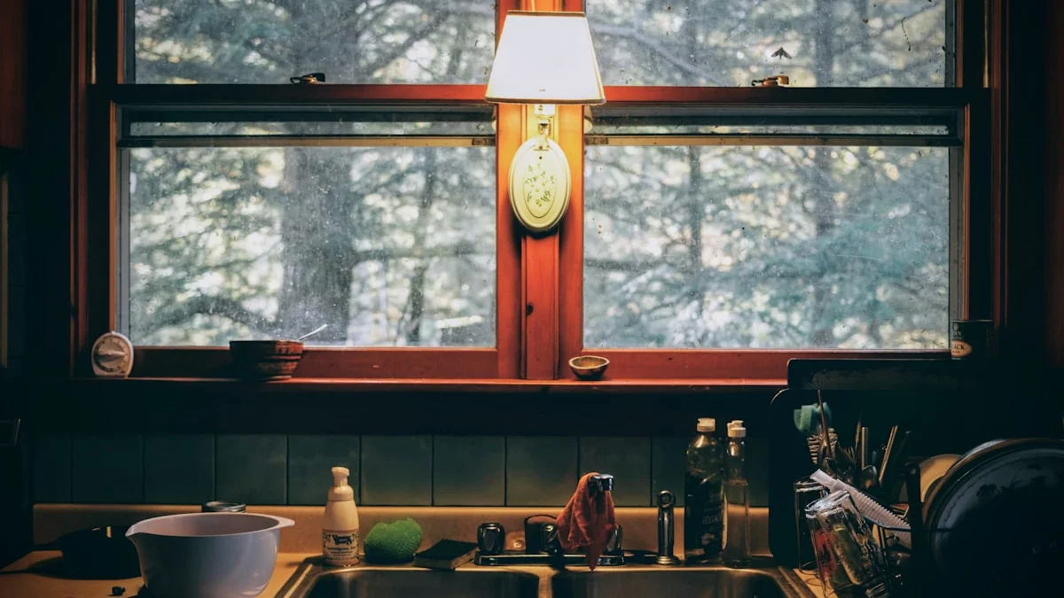A small lamp glows beside a kitchen window at dusk, the dark forest blurred outside the glass. — a The Obsidian Key guide to The Key Protocol and Your Emotional Tone.
