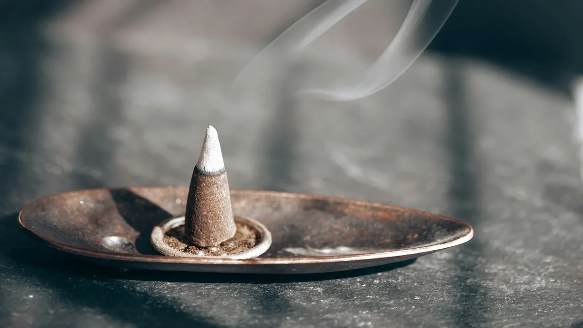 A cone of incense smolders on a stone table as thin smoke rises through window light. — a The Obsidian Key guide to Laws One and Two Together: From Still Seat to Sentence.