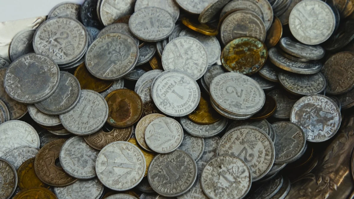A pile of tarnished old coins heaped on a metal tray. — a The Obsidian Key guide to Leakage vs Spending: Who Did the Buying.