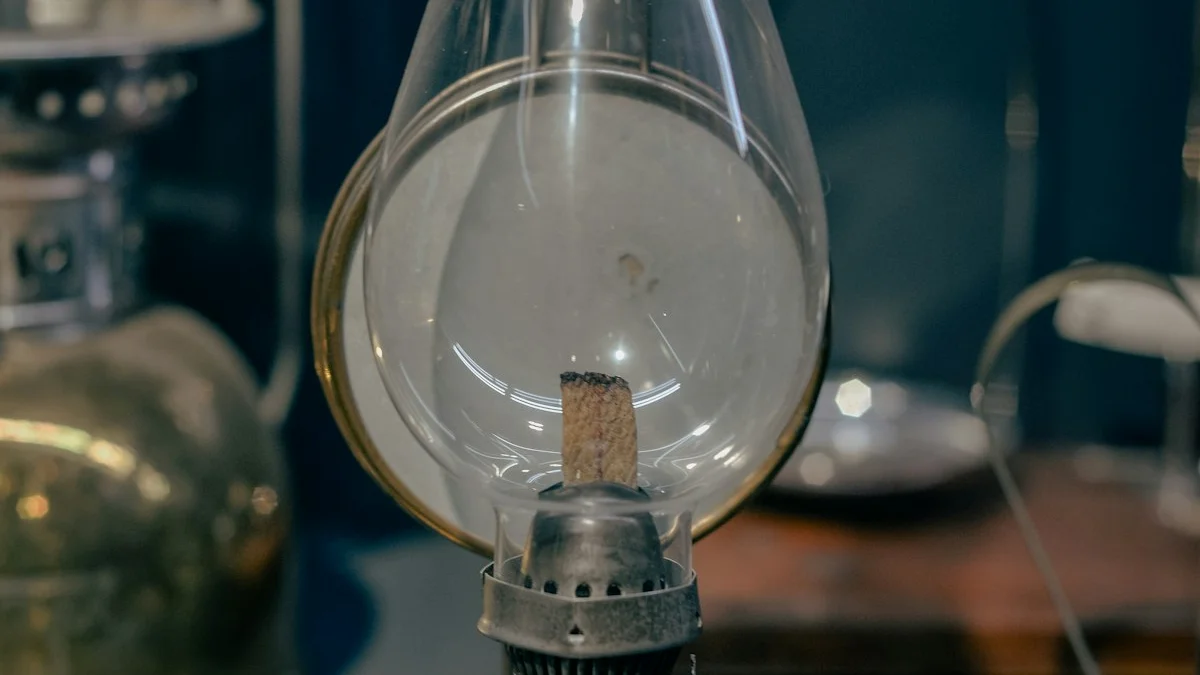 An antique glass oil lamp with a brass burner stands unlit on a darkened table. — a The Obsidian Key guide to Lucian Vael on Mornings: the Hour Before the Current.
