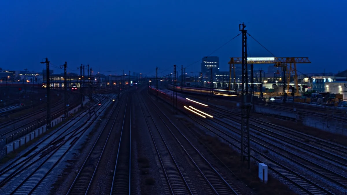 Railway tracks fanning out under a dusk sky with a train light trail. — a The Obsidian Key guide to A Monastery Can Be Loud Inside.