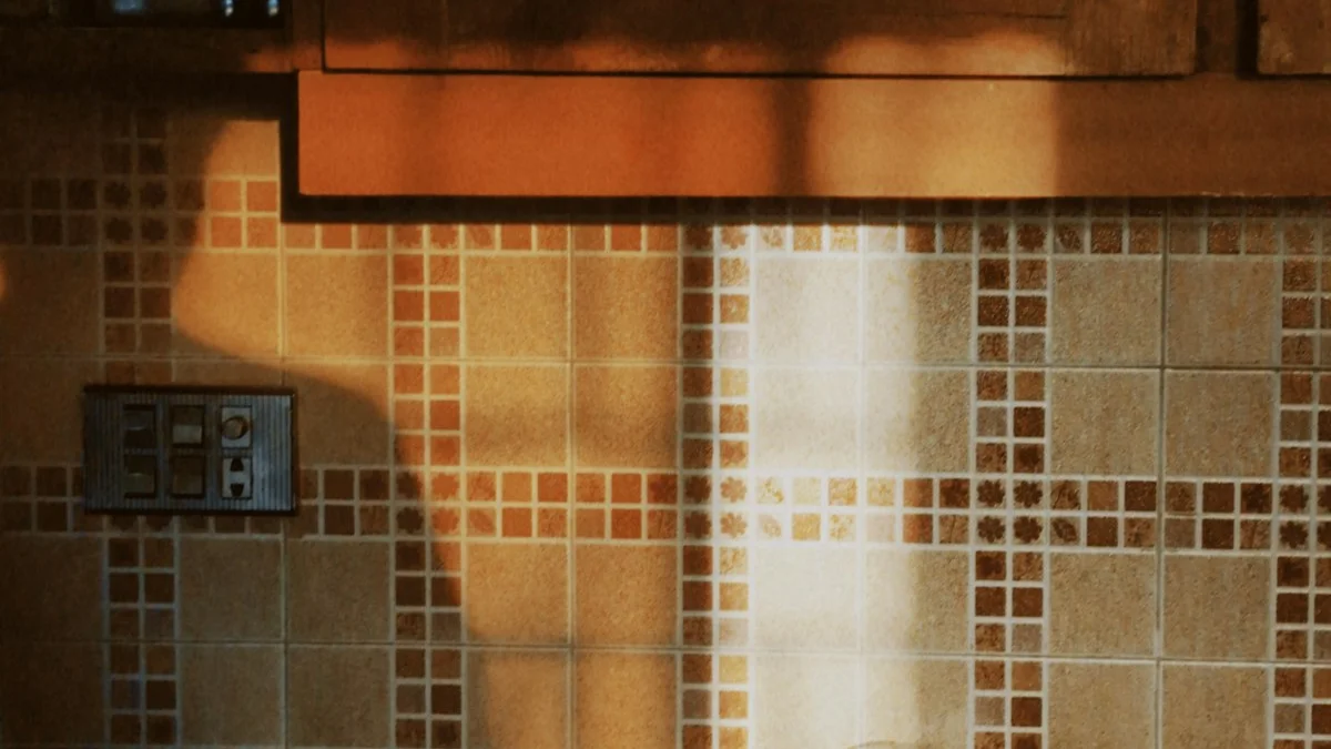 Warm golden sunlight falls across the tiled wall of a family kitchen. — a The Obsidian Key guide to A Morning Ritual for Parents in a Full House.