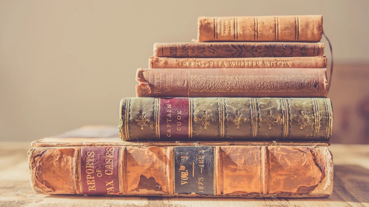 A stack of worn leather-bound hardcovers rests on a wooden table in warm light. — a The Obsidian Key guide to The Obsidian Key on Emotion: A Chapter Guide.