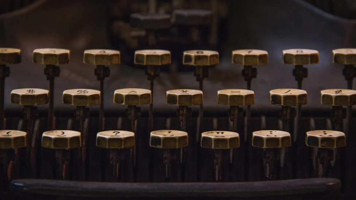 Vintage brass typewriter keys in low warm light. — a The Obsidian Key guide to The Obsidian Key Part I Summary: The Veil.