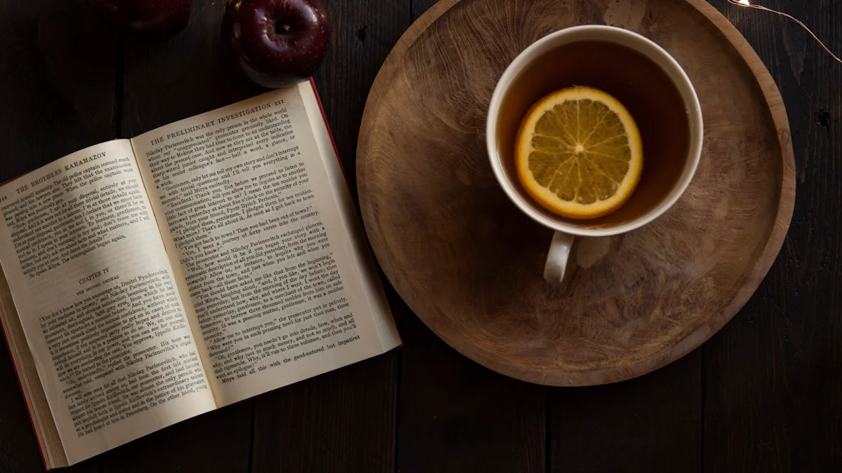 An open paperback lies beside a wooden tray with a cup of lemon tea on a dark table. — a The Obsidian Key guide to Obsidian Lore Check: Book Facts vs Fan Theories.