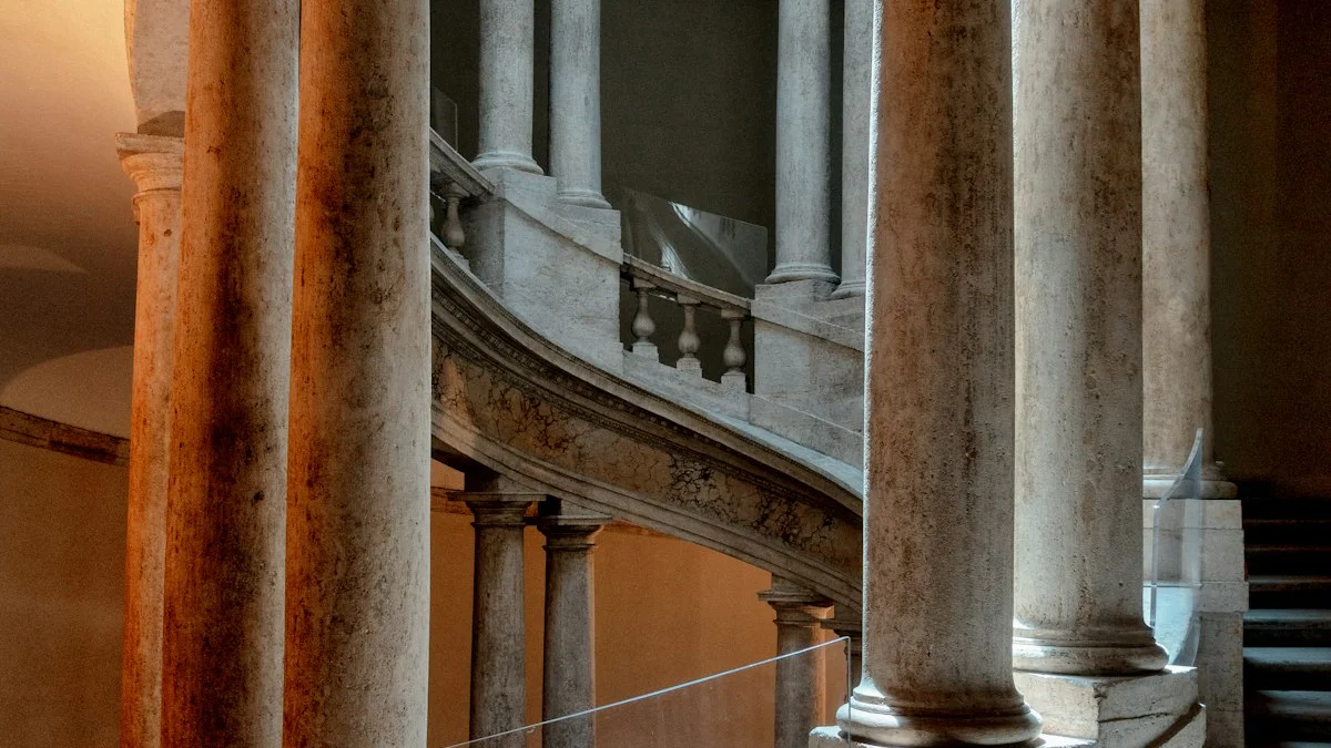 A marble staircase curves between tall carved columns in warm amber light. — a The Obsidian Key guide to Reality Architecture for Beginners: Learn the Model First.