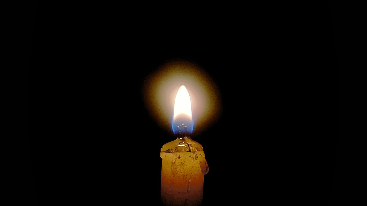 A single lit candle glows in a dark quiet room. — a The Obsidian Key guide to The Recovery Rite: a Same Day Reset After Conflict.