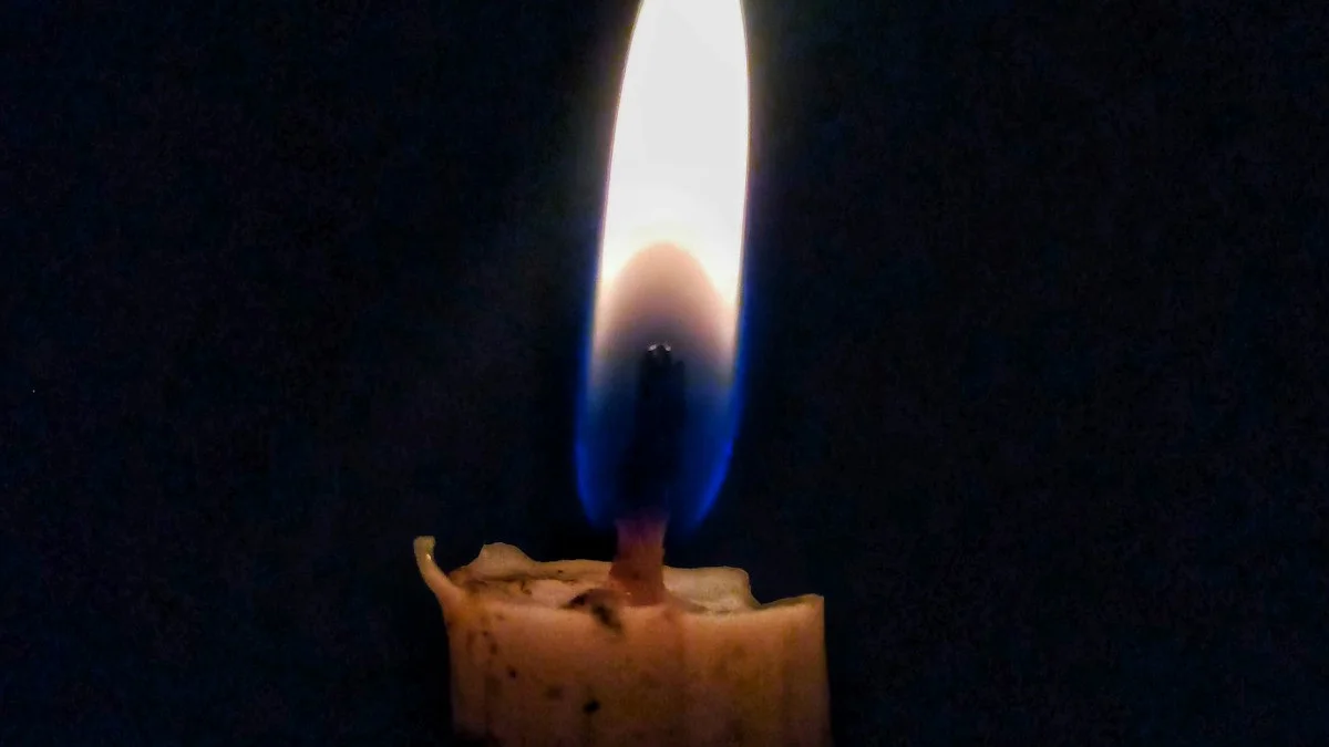 A single lit candle burning in darkness. — a The Obsidian Key guide to Resume Never Restart: The Rule for a Missed Day.