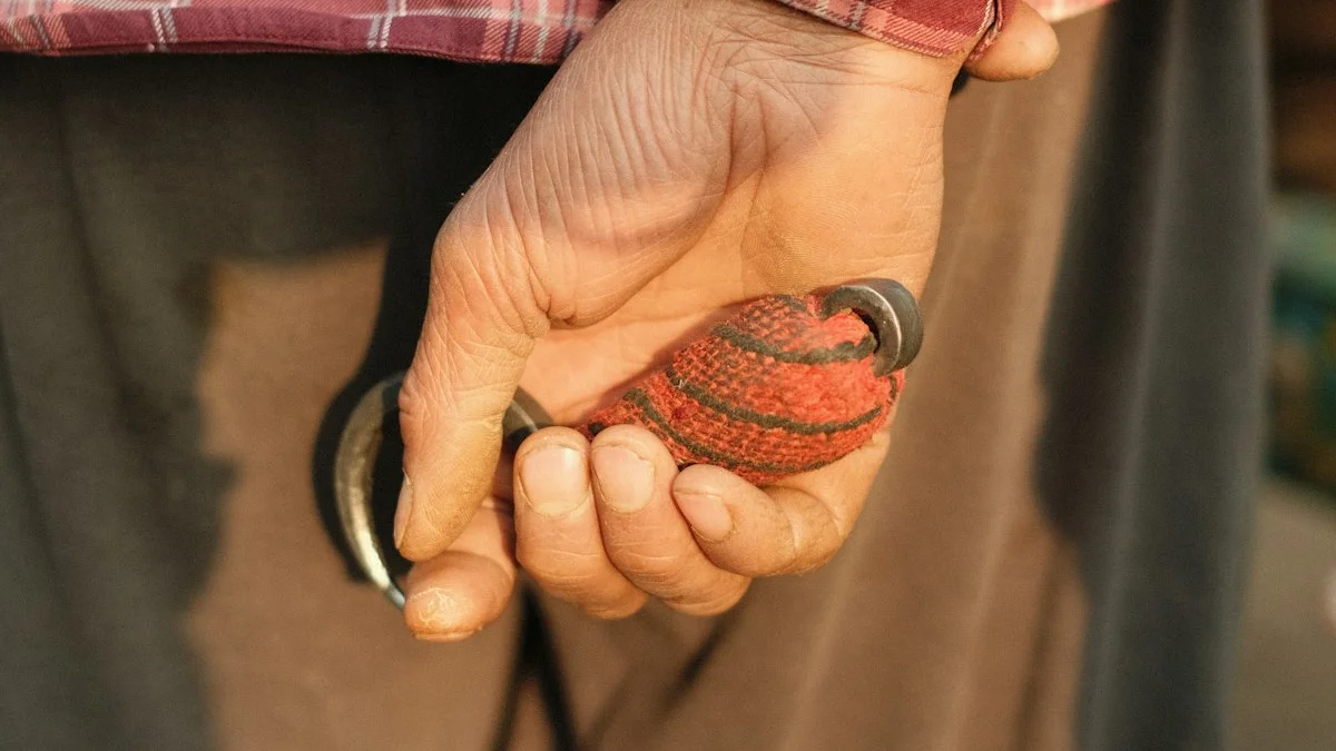 Closed hand held behind a plaid shirt gripping a red woven object tightly. — a The Obsidian Key guide to Scarcity Mindset: The Clench Explained.
