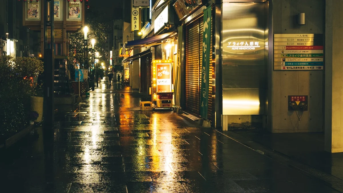 Rainy city street at midnight with warm lights reflected on wet pavement. — a The Obsidian Key guide to An Evening Ritual for Shift Workers and Night Hours.