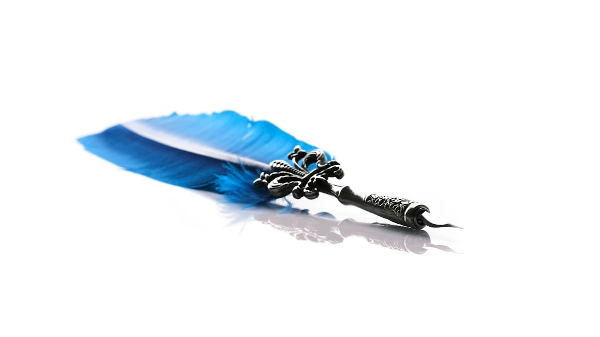 An ornate blue feather quill with a black metal nib lies against a plain white background. — a The Obsidian Key guide to The Boundary Sentence: One Line of Defense.