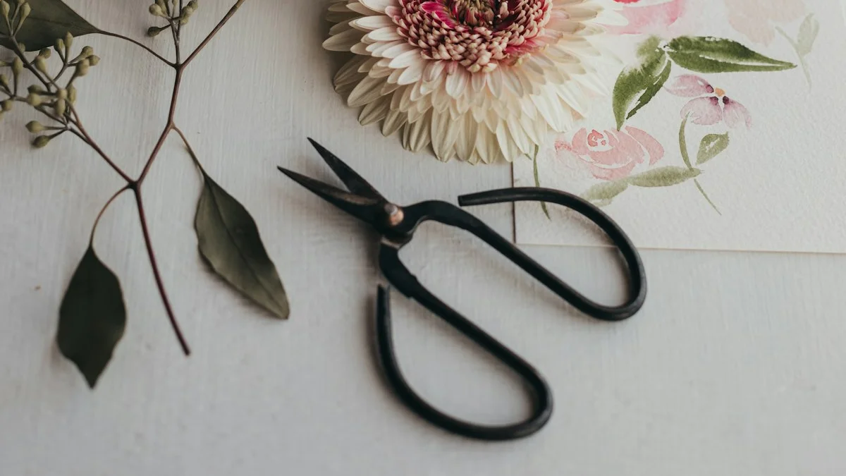 Black scissors resting on a pale desk beside a spiral notebook and dried flowers. — a The Obsidian Key guide to The Cutting: The Severance Rite Defined.