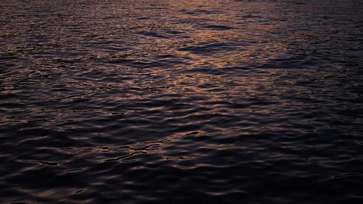Dark water surface with gentle ripples catching warm sunset light. — a The Obsidian Key guide to The Drowning Man Mistake: Wanting It Like Air.