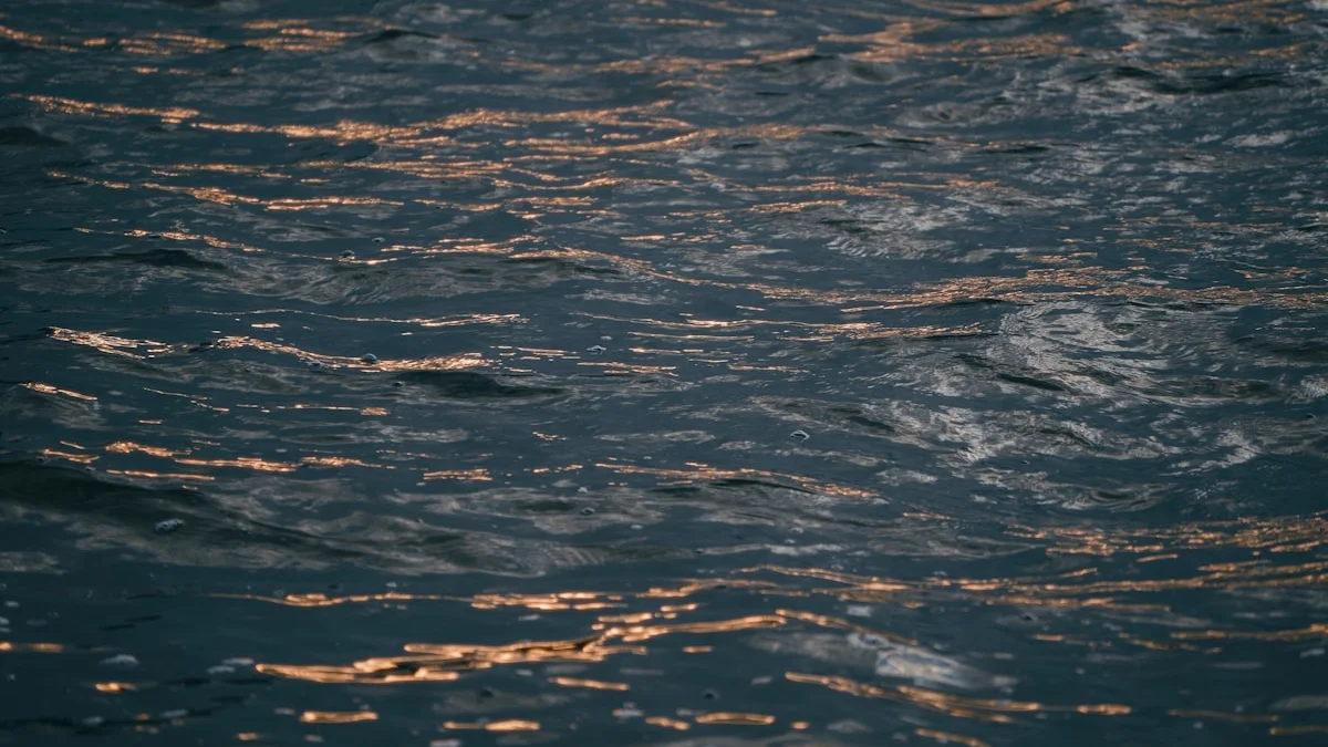 Dark rippling water at dusk scattered with golden light reflections. — a The Obsidian Key guide to The Field: The Medium That Matches Your Signal.