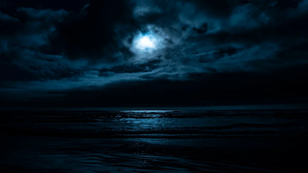 Moonlight breaks through dark clouds and reflects on a still night sea. — a The Obsidian Key guide to The Field: The Responsive Medium That Matches You.