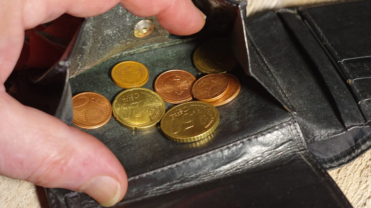 A hand lifting old coins from an open black leather wallet. — a The Obsidian Key guide to The Opened Hand: The Wealth Posture Defined.