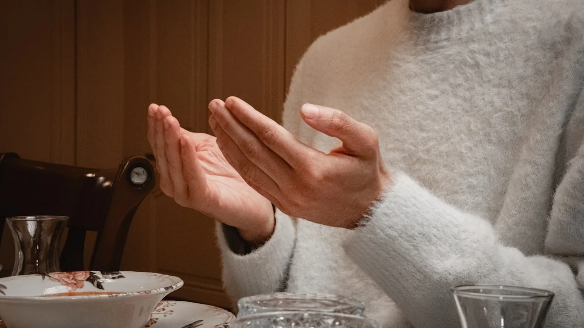 Open palms turned upward in a receiving gesture above a set table in warm light. — a The Obsidian Key guide to The Opened Hand: The Doctrine of Receiving.