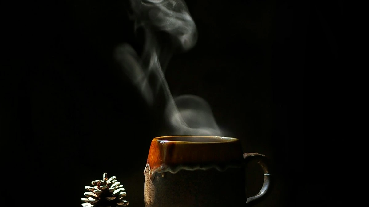 Steam rises from a handmade ceramic mug lit by warm light in a dark room. — a The Obsidian Key guide to The Seal Statement: One Sentence Each Morning.
