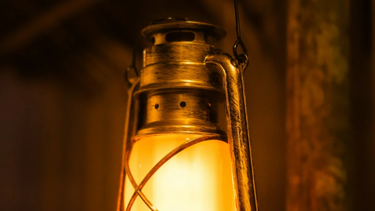 An antique brass lantern glows warmly against the dark. — a The Obsidian Key guide to The Sealing Statement: Close Your Circuit Before Sleep.