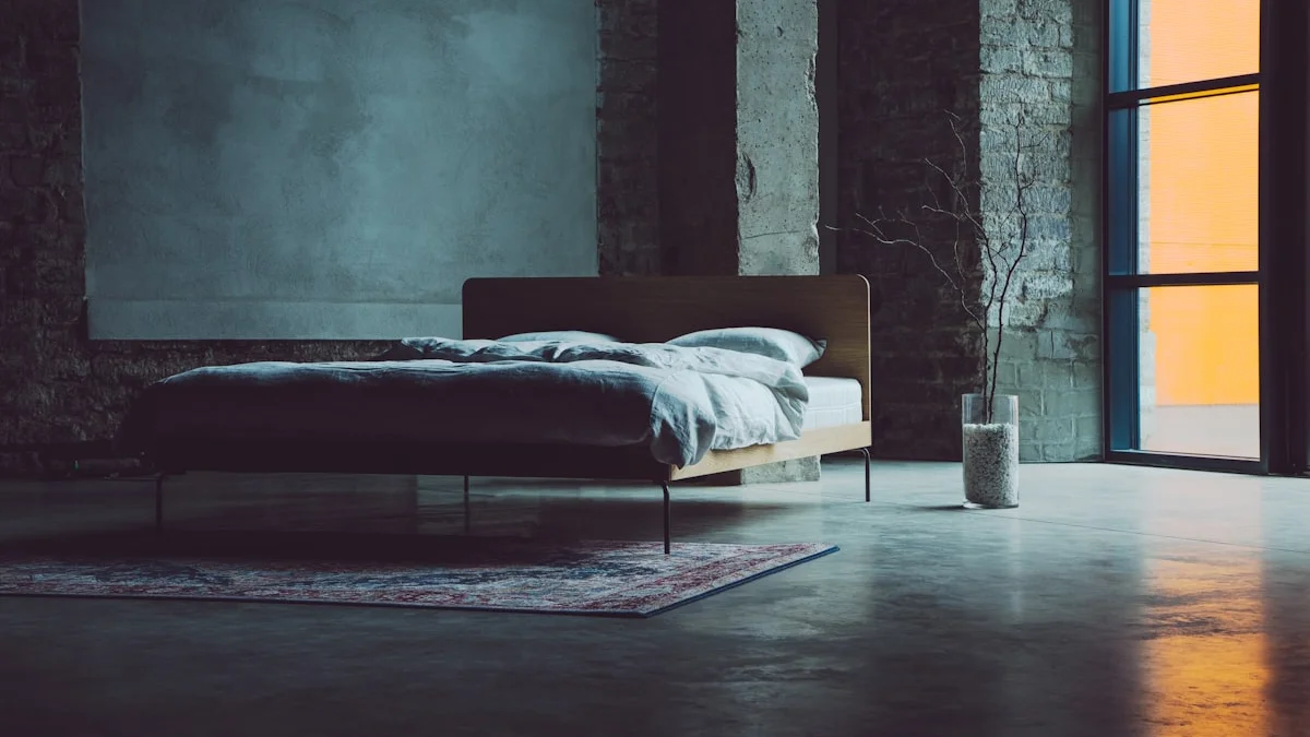 A low bed stands in a dark concrete bedroom beside a warm orange window. — a The Obsidian Key guide to The Second Law: The Assumed State.