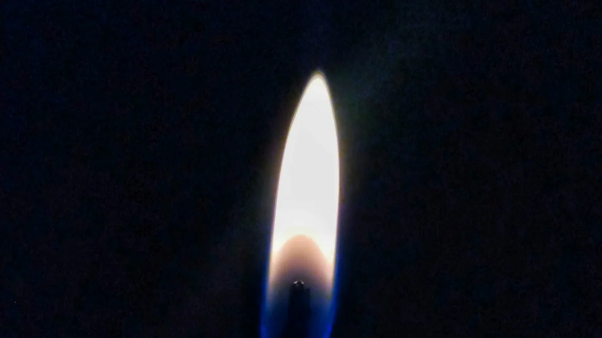 A single steady candle flame burns white and gold against the dark. — a The Obsidian Key guide to The Shield Operation: A Standing Defense Not a Wall.