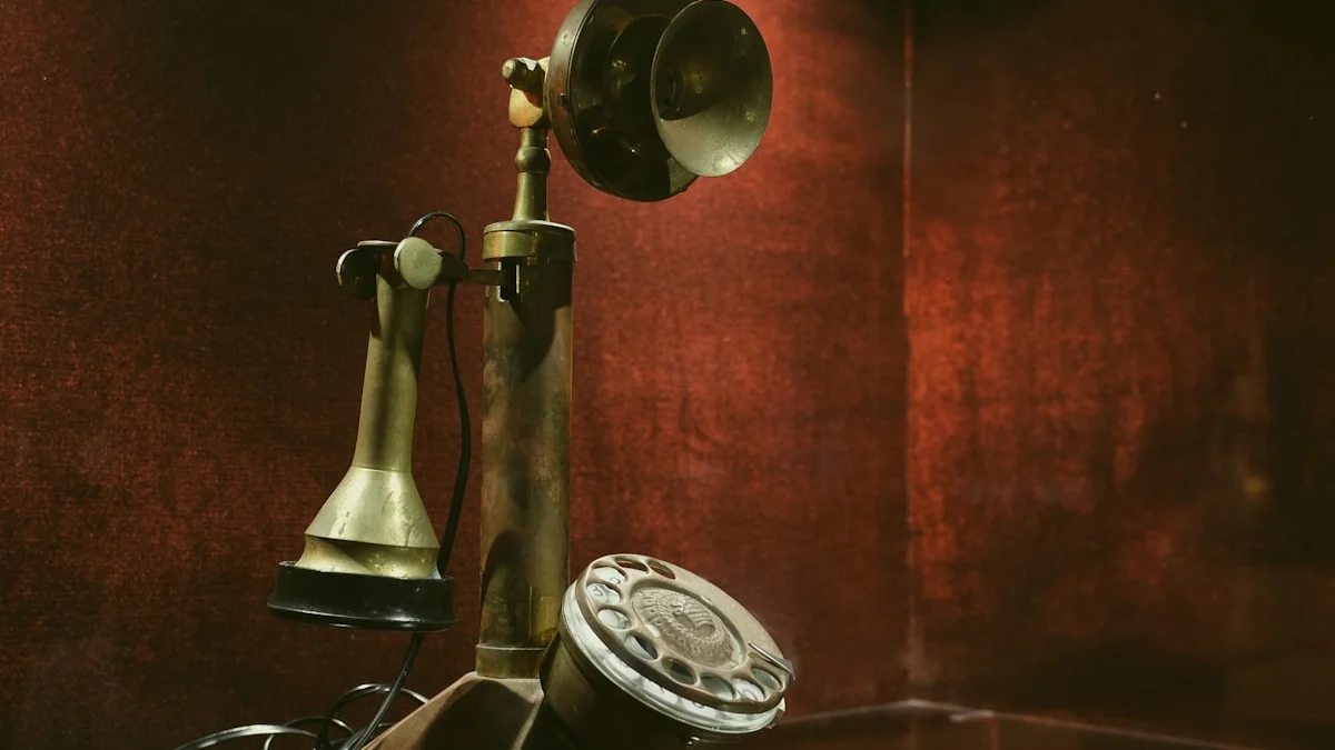 An antique brass candlestick telephone standing against a dark red wall. — a The Obsidian Key guide to The Signal: Your Total Broadcast Defined.