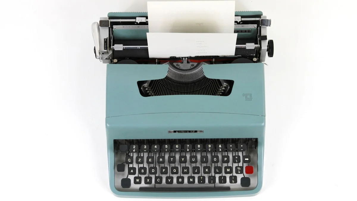 A vintage teal typewriter holds a blank sheet of paper, seen from above. — a The Obsidian Key guide to The Wealth Sentence: An Identity Never an Amount.
