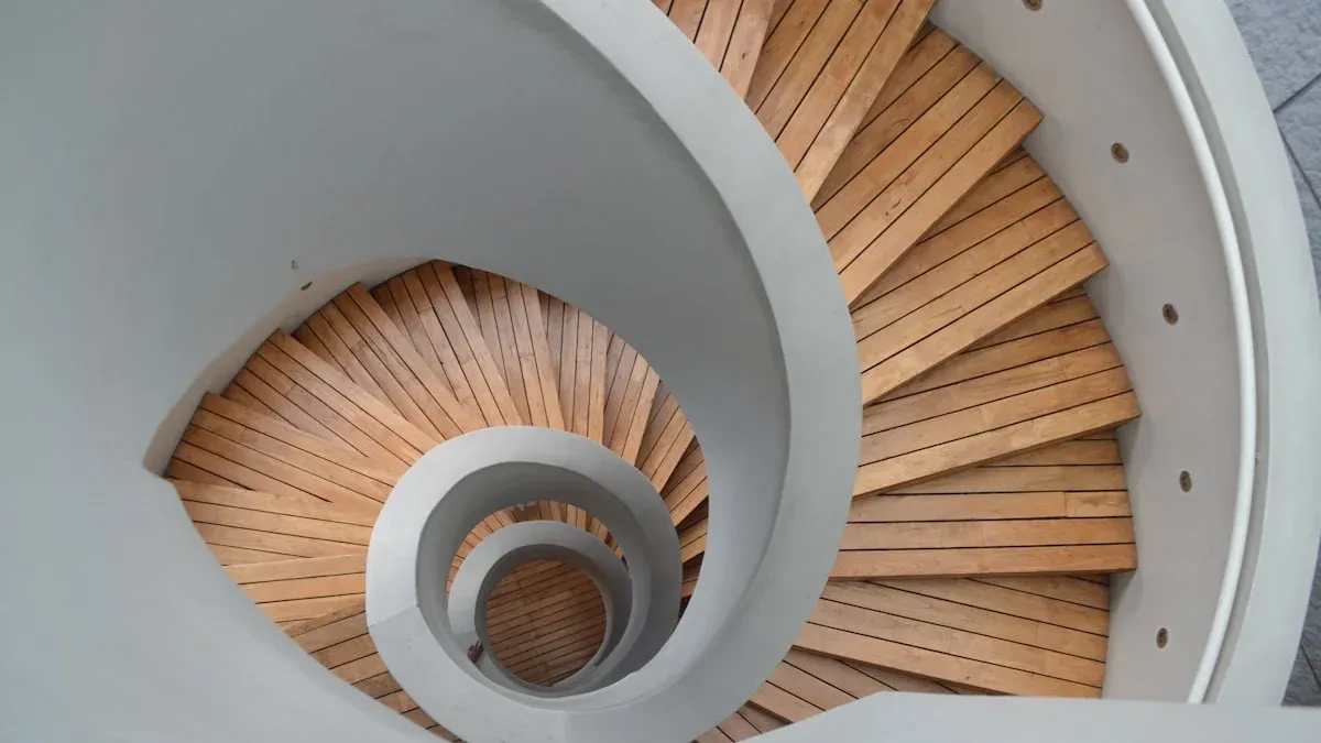 A wooden spiral staircase winds through warm light, its turning steps seen from above. — a The Obsidian Key guide to Week Two of the Path: Assumption and Compounding.