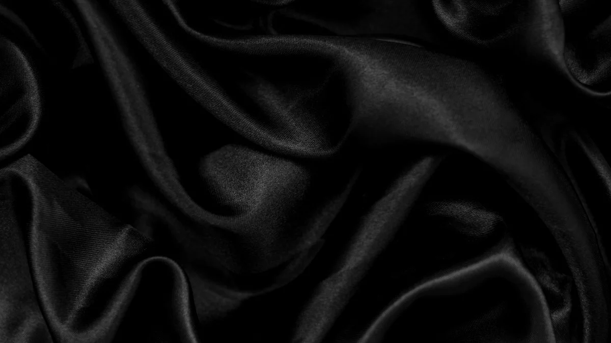 Folded black satin fabric falls in soft waves across the frame. — a The Obsidian Key guide to Veil vs Architecture: The Curtain and the Machinery.