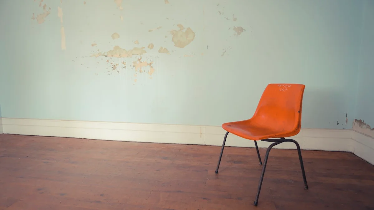 A single orange chair with black metal legs stands against a pale worn wall on a wooden floor. — a The Obsidian Key guide to Wanting Is a Position: The Geometry of Lack.
