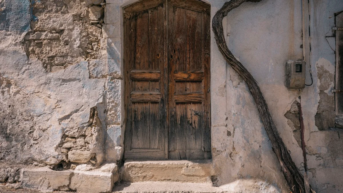 A weathered wooden double door with a worn stone threshold and steps in an old plastered wall. — a The Obsidian Key guide to Wanting vs Assuming: The First Lesson.