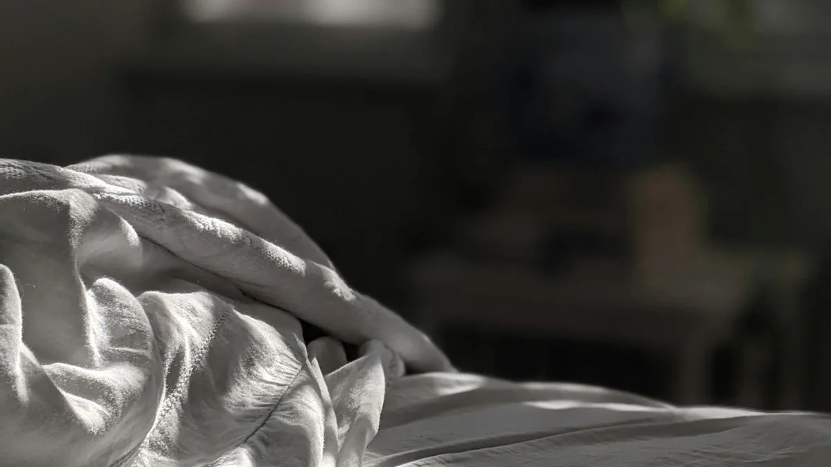 Sunlight falls across white bed linen in a dim, quiet room. — a The Obsidian Key guide to What to Expect When You Read The Obsidian Key.